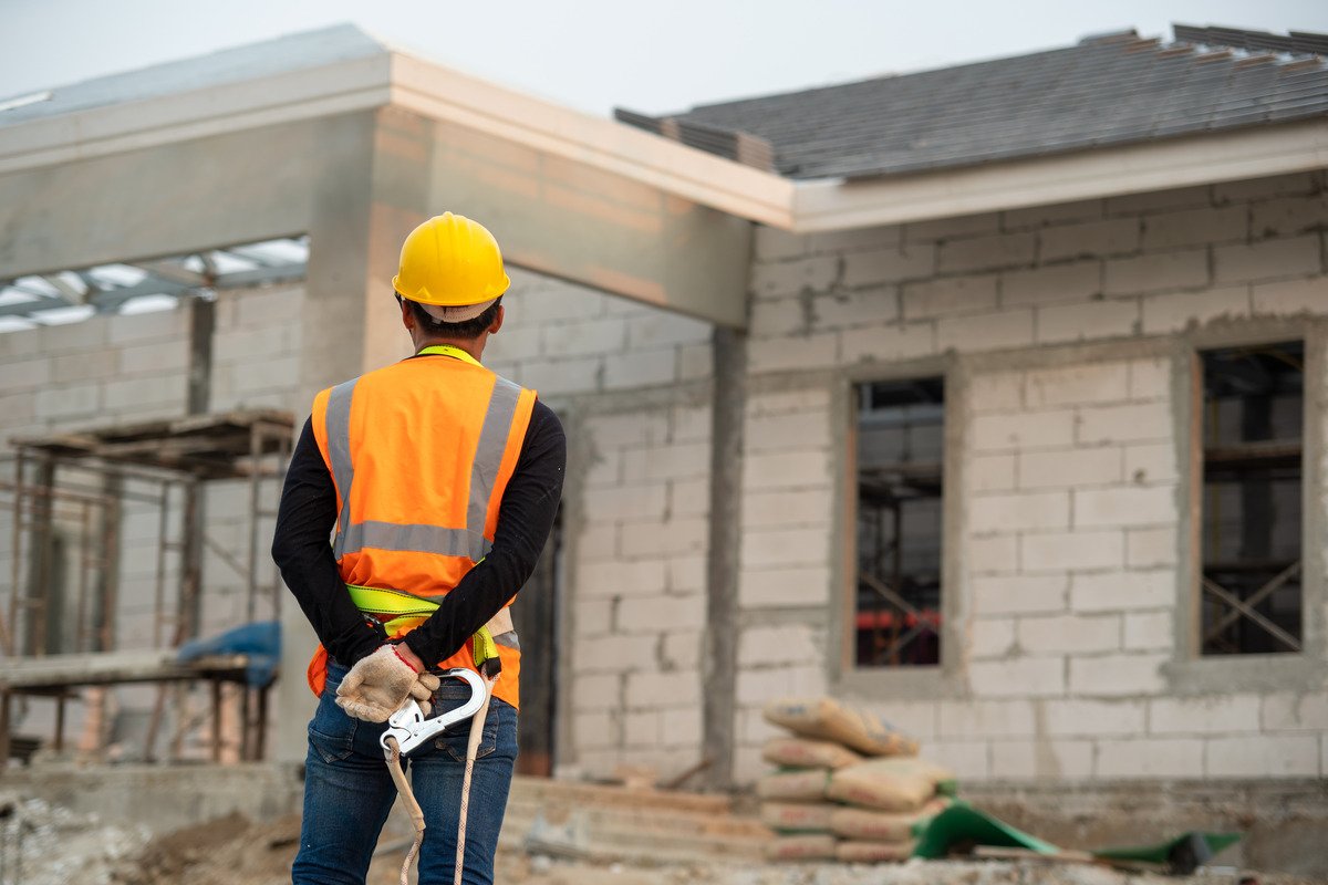 construction worker wearing safety harness safety line standing construction site